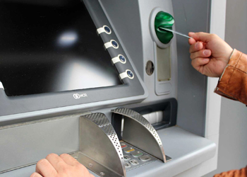 Customer Putting Credit Card into ATM Machine