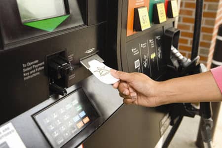 Person Receives Receipt At Gas Statio Pump