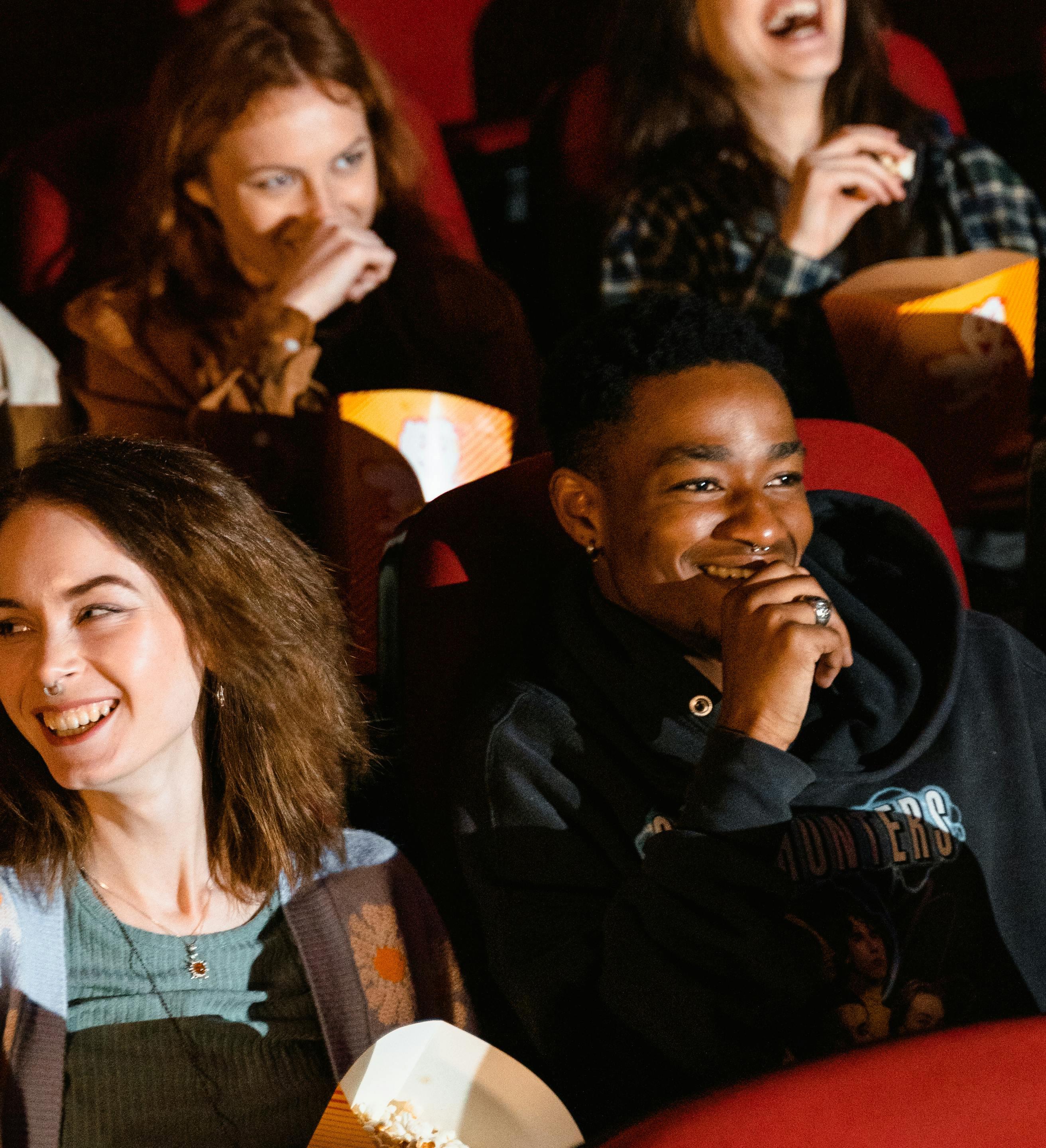 Moviegoers Laughing & Eating Popcorn